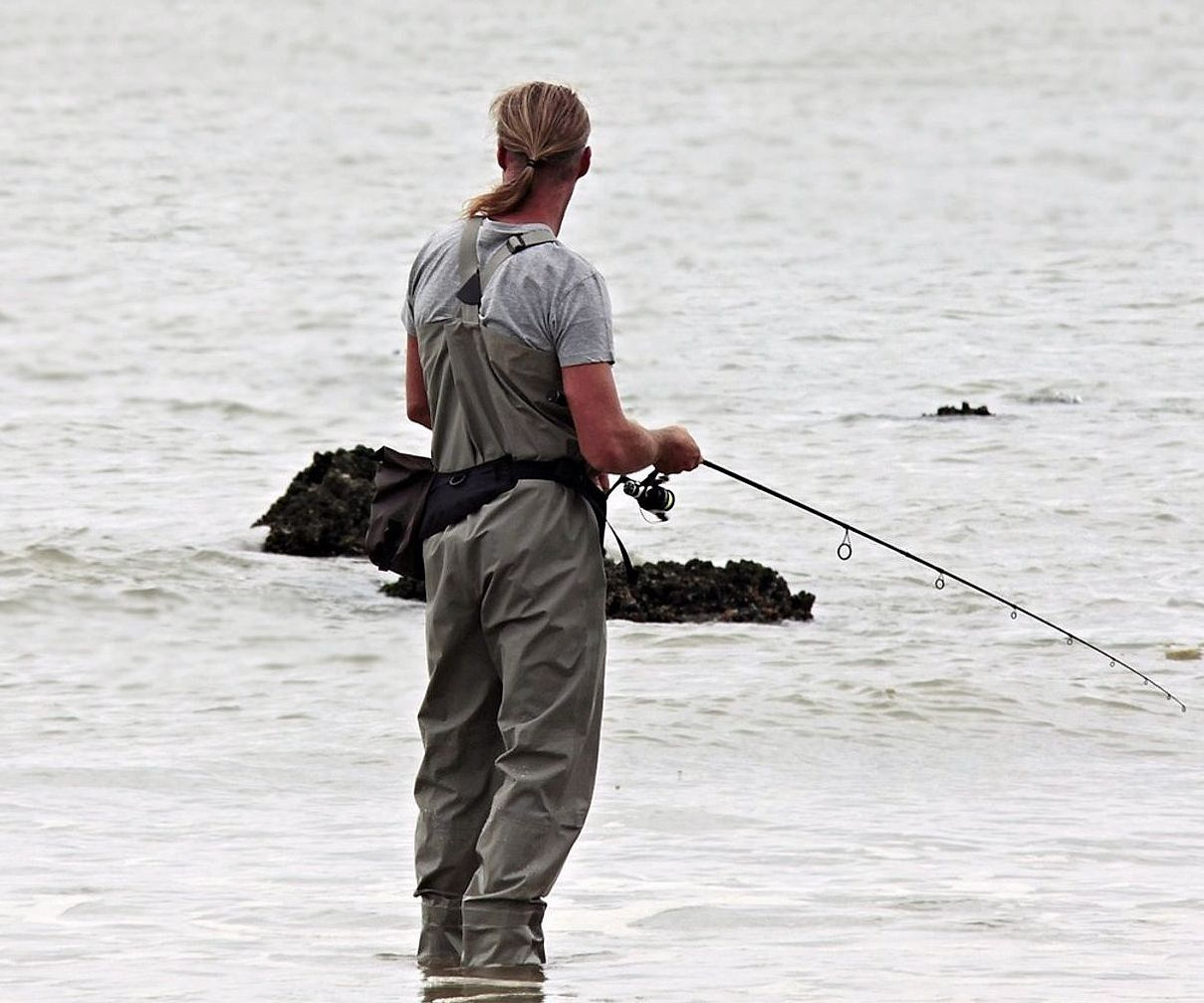 Anglers preparing tackle and checking weather conditions